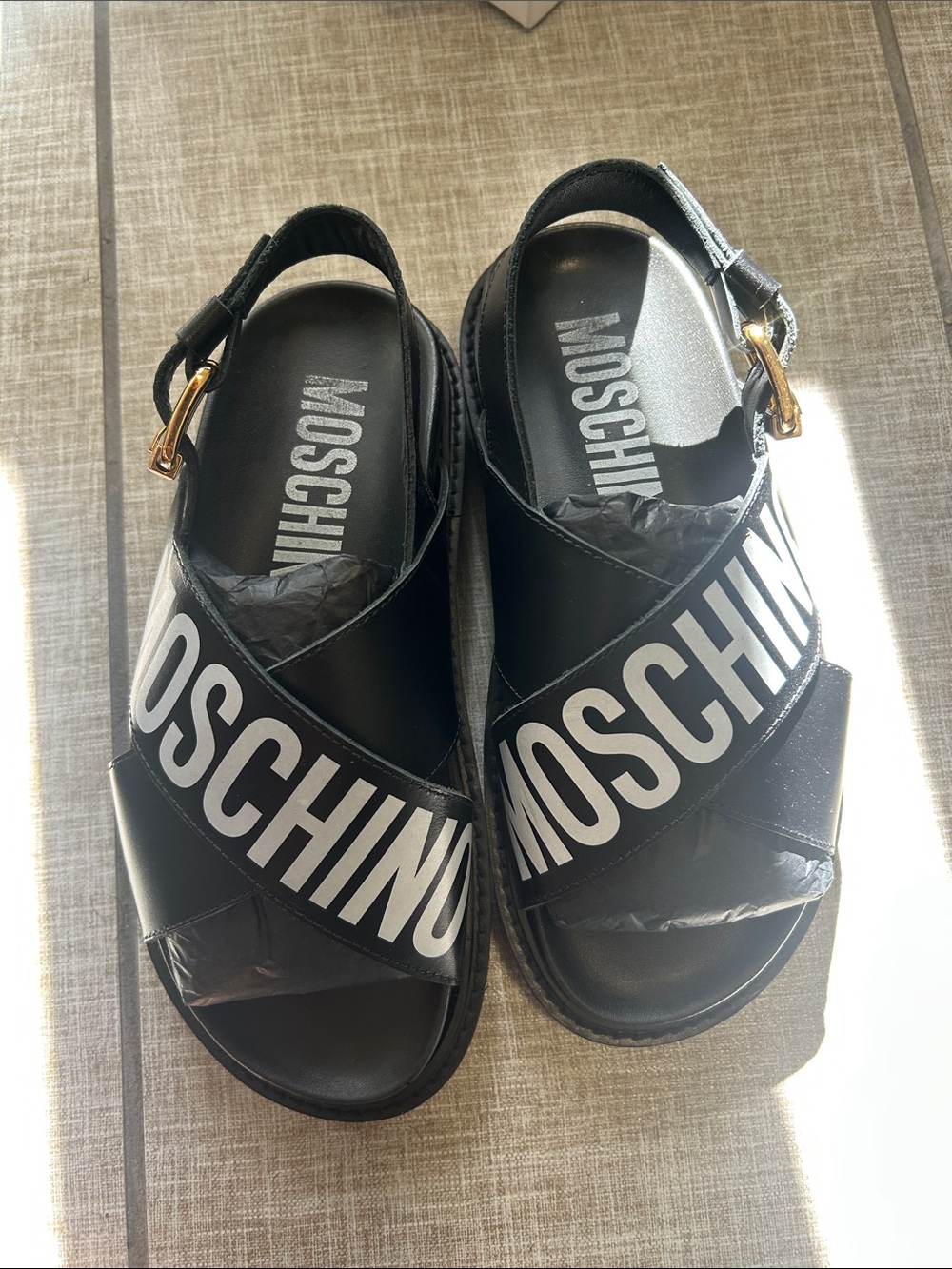 Moschino Black Sandals with White Logo Cross Straps and Gold Buckle